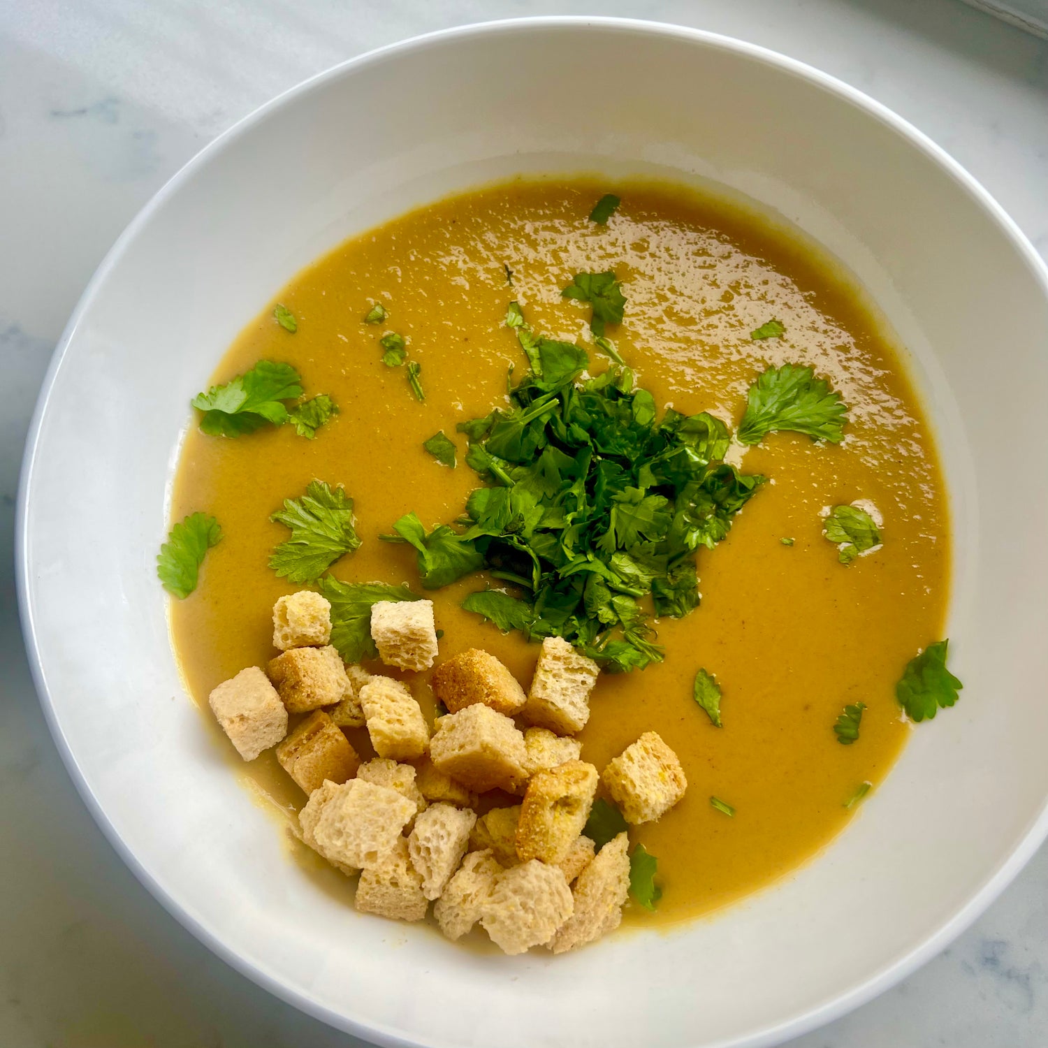 Pumpkin Soup with Crouton, Coconut Cream and Chopped Parsley